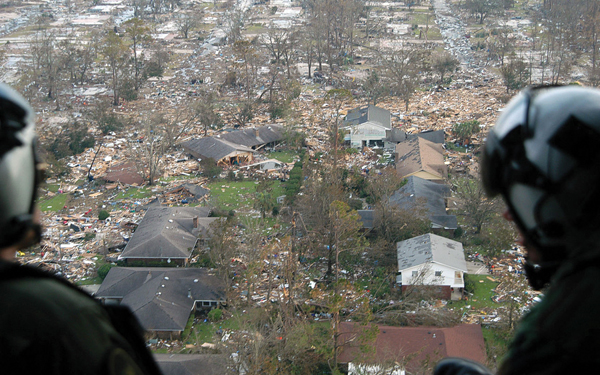 U.S. Navy crewmen surveying damage from Hurricane Katrina