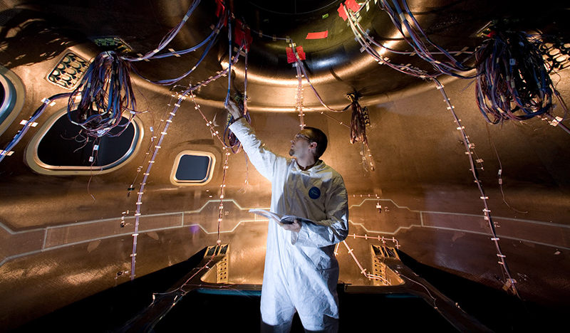 Engineer examining the Orion capsule
