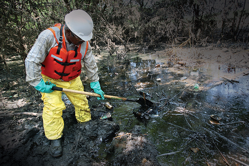 Worker cleaning an oil spill