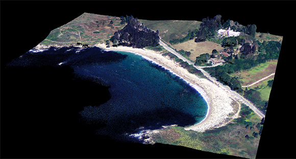 A lidar point cloud colored using simultaneously acquired photography by a Sigma Space imager shows the trees, grass, beach, and surf at Point Lobos in California.