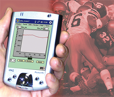 Temperature data on a personal digital assistant with football players in the background