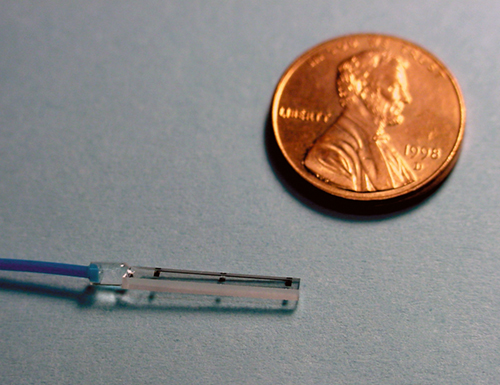 The Photrode™ all-optical sensor next to a penny shown for scale