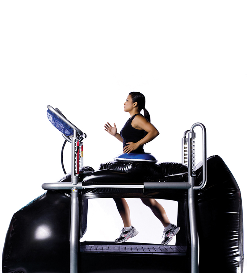 An athlete runs in the pressurized, enclosed G-trainer treadmill