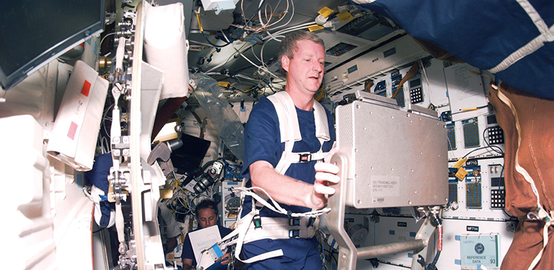 Astronaut Steven Hawley runs on the International Space Station treadmill