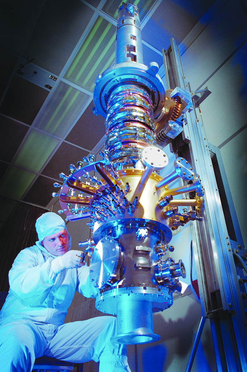 An engineer in a clean suit assembles the Gravity Probe B spacecraft