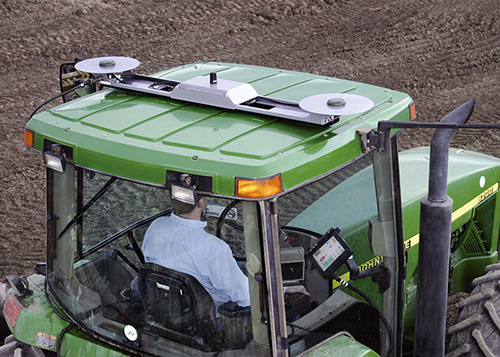 GPS system antennas roof-mounted on a farming tractor