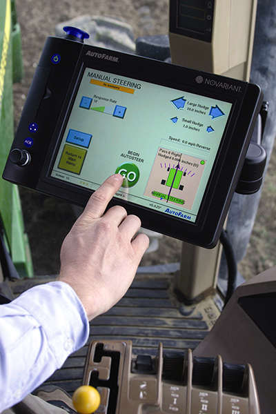 A farmer uses a touch screen console mounted on his tractor to control Auto steer