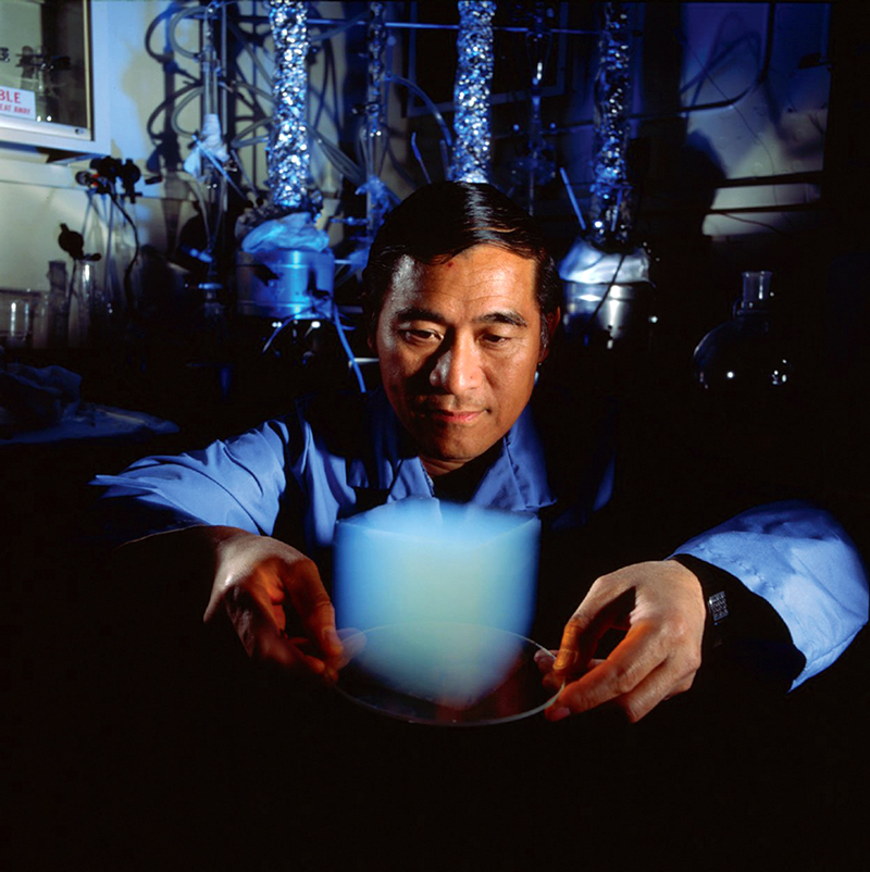 A scientist holds a transparent, ghostly block of Aerogel.