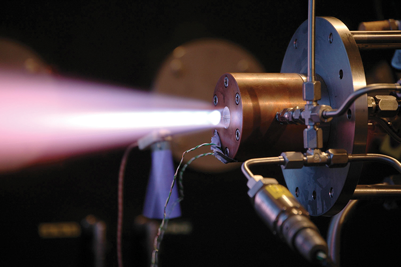 A rocket propulsion thrust chamber firing a bright flame