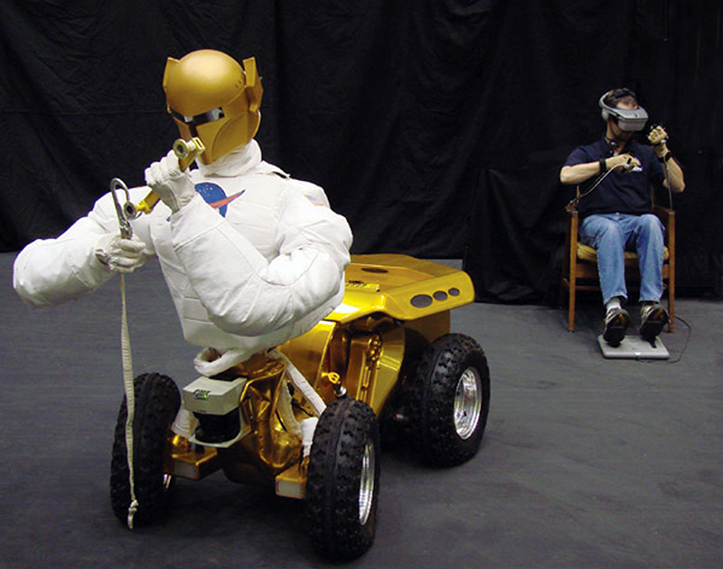 Guided by a human operator nearby, NASA’s Robonaut manipulates equipment with its hands