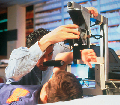 A physician uses the Mechanical Response Tissue Analyzer on a young patient's wrist