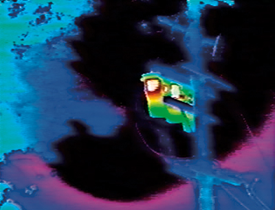 Infrared image of a transformer on a telephone pole.