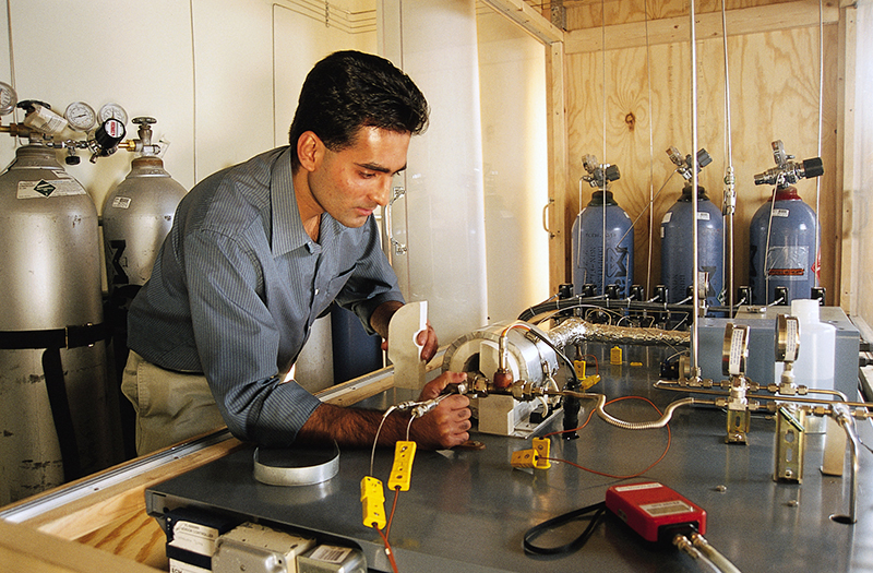 Dr. Paul Menacherry working with a custom-built test rig used to simulate automotive exhaust gas
