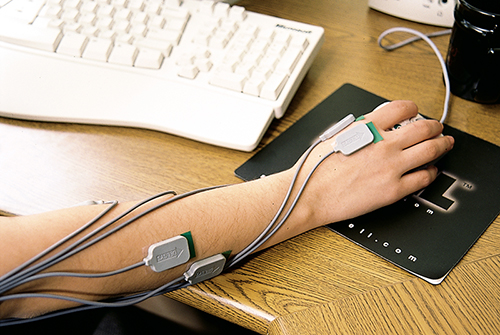 Arm wearing MyoMonitor and using computer mouse