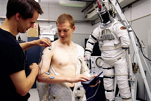 MyoMonitor being attached to a man's arm in order to study the muscles of astronauts