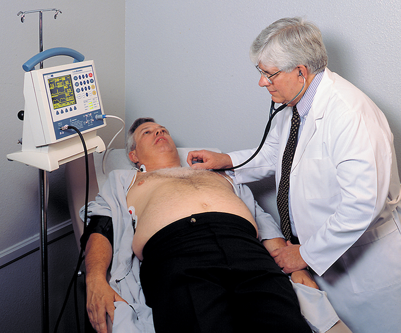 A doctor monitors a patient’s hemodynamic status