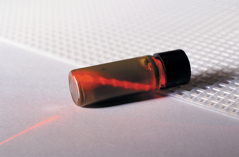 a vial with a laser passing through it during a sampling procedure