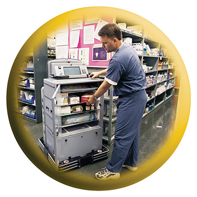 A healthcare worker loads supplies into the robotic courier