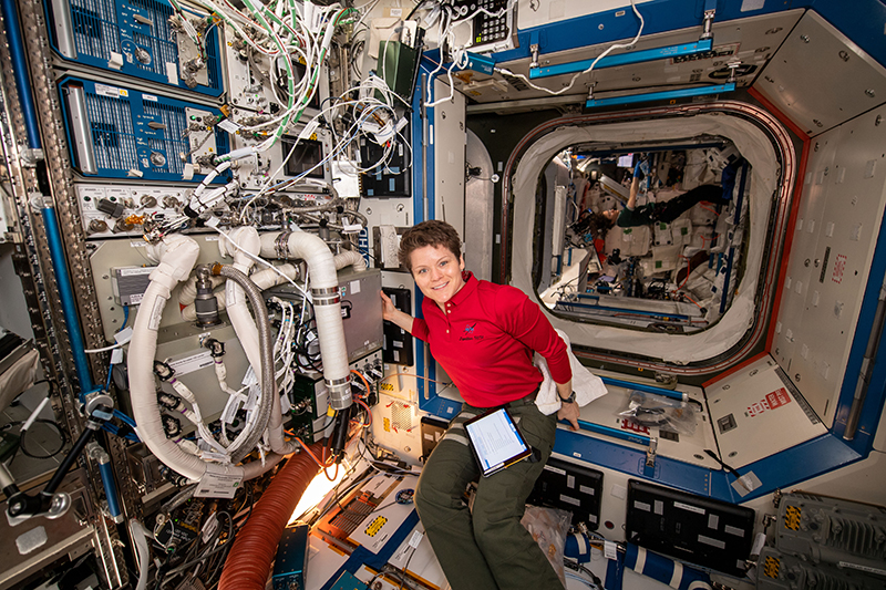 Astronaut on International Space Station with air scrubber