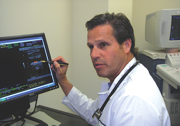 A physician uses a computer