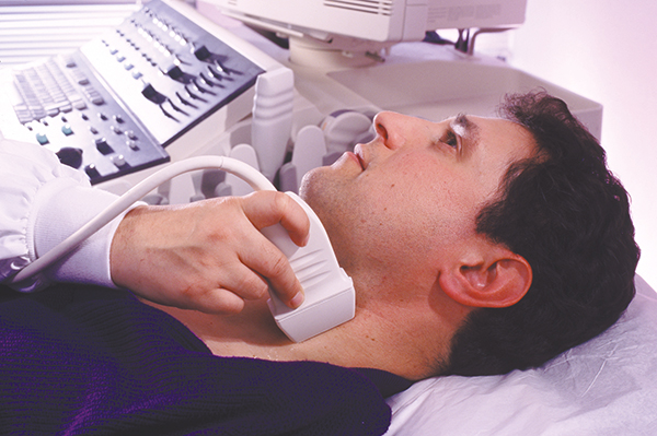 A patient getting an ultrasound of his neck