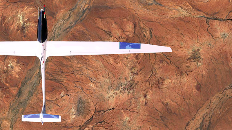 The HiDRON glider soaring over a desert landscape