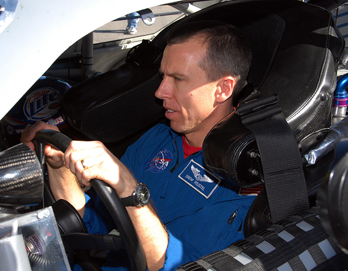 Astronaut Drew Feustel behind the wheel of a NASCAR racing vehicle