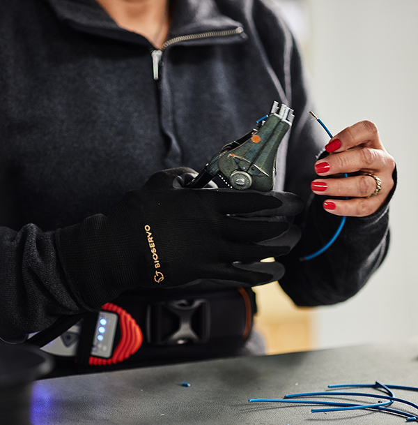 The Ironhand glove being used by a factory worker with pliers