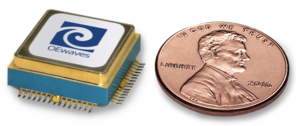 An OEwaves optoelectrical oscillator next to a penny to show size