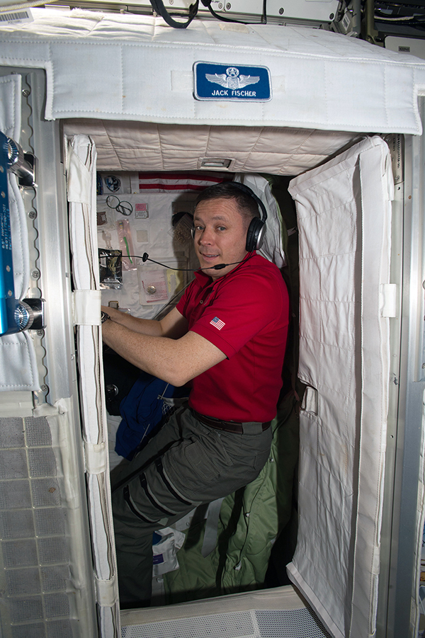 An astronaut in his sleeping cabin