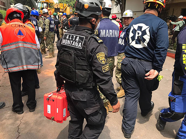 An emergency responder in Mexico City carries an X3 FINDER while responding to a 7.1 magnitude earthquake