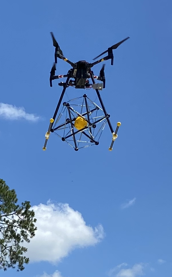 A drone transports one of Squishy Robotics’ tensegrity robots