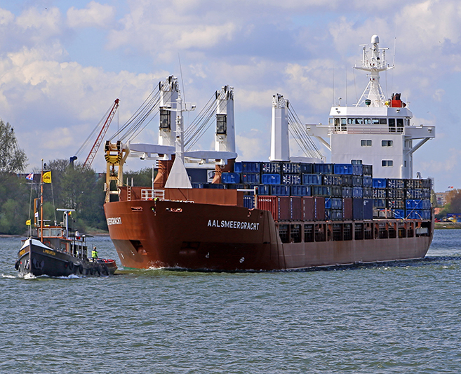 Cargo ship with tugboat