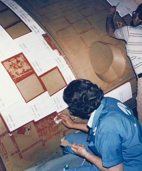 Workers applied hundreds of ceramic tiles on the outside of the space shuttle