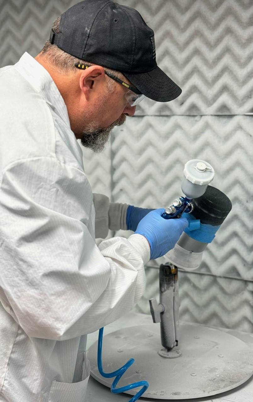 A Canopy employee sprays TPS tiles