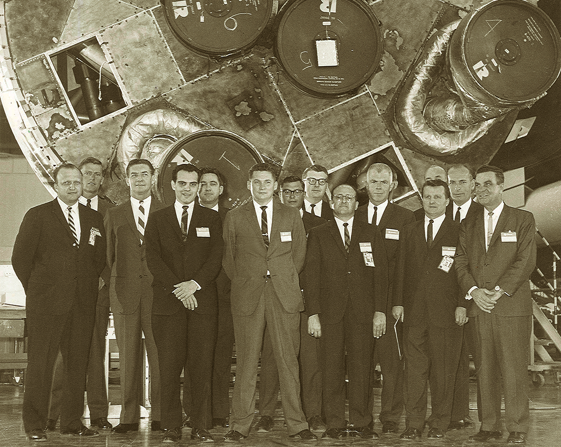 Marotta Controls founder Pat Marotta, far right, poses with members of his company and others in front of the Saturn I main booster in 1963