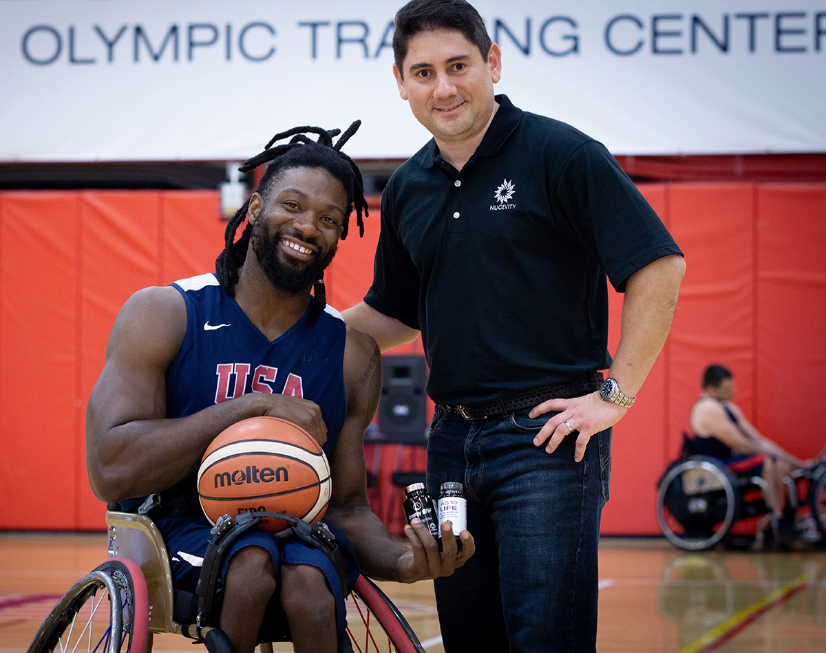 Matt Scott, a five-time Paralympian and a double gold Paralympic medalist, poses with Carlos Montesinos, managing director and chief scientist at Nugevity