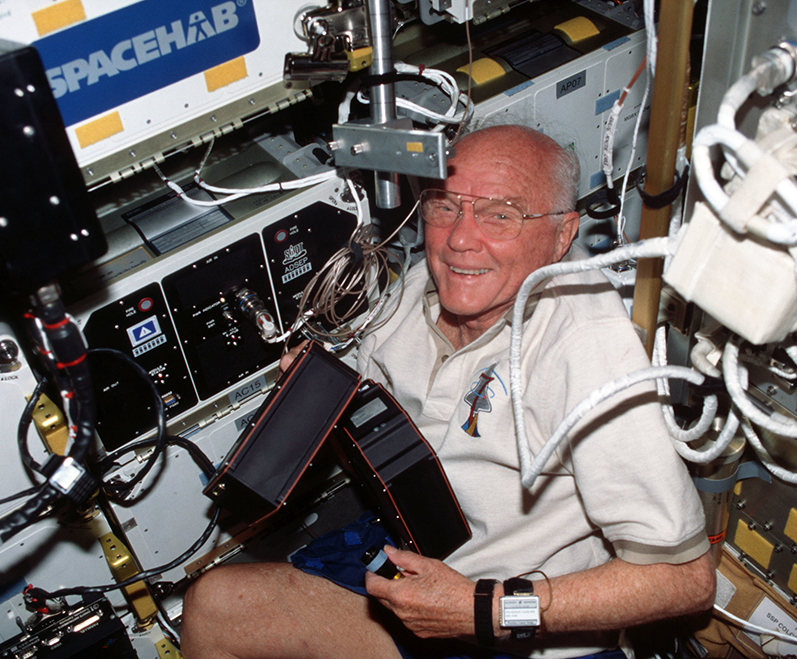 Legendary astronaut and U.S. Senator John Glenn facilitates ADSEP experiments on a space shuttle Discovery mission in 1998