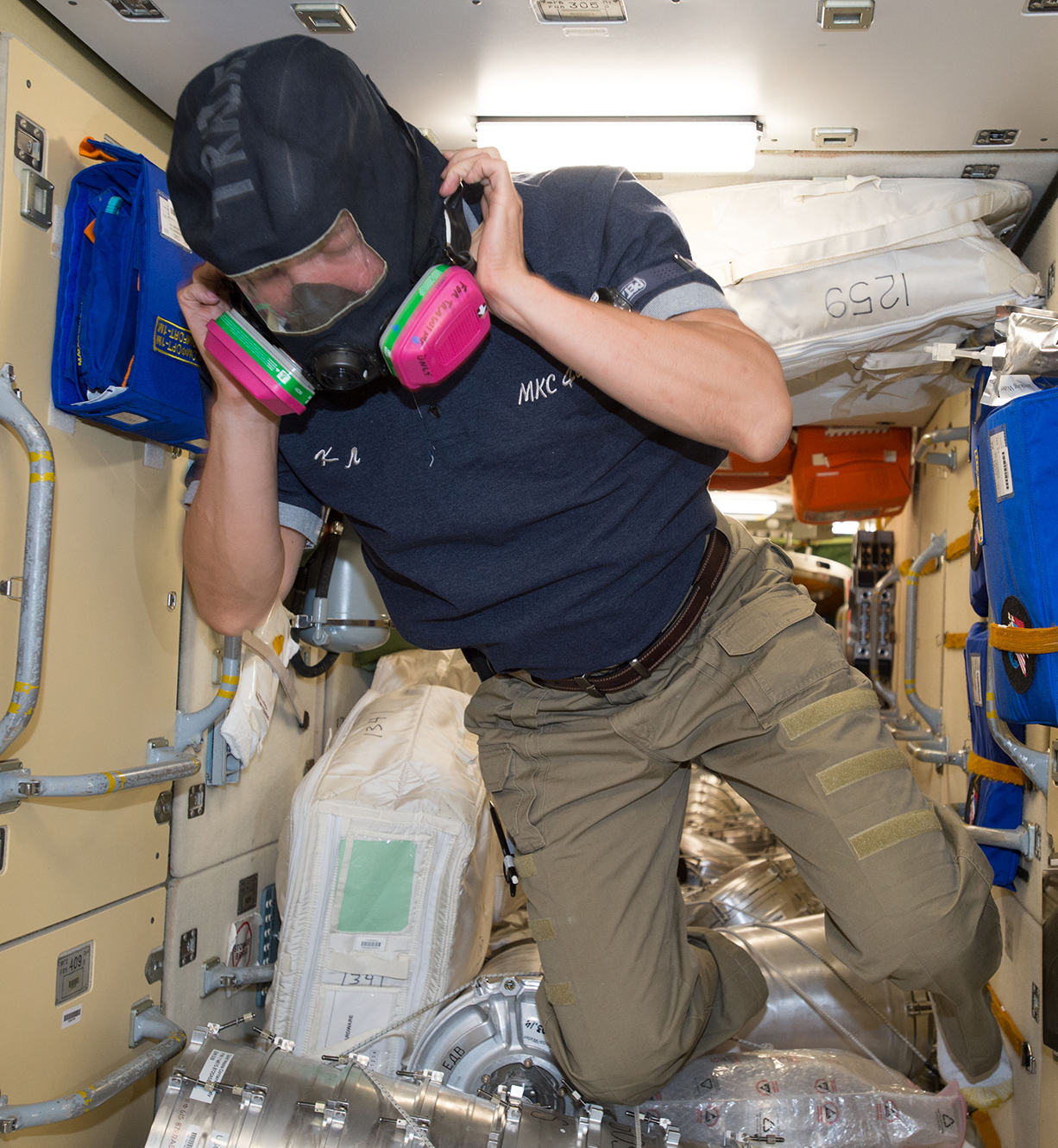 An astronaut on board the International Space Station wear a special fire fighting mask