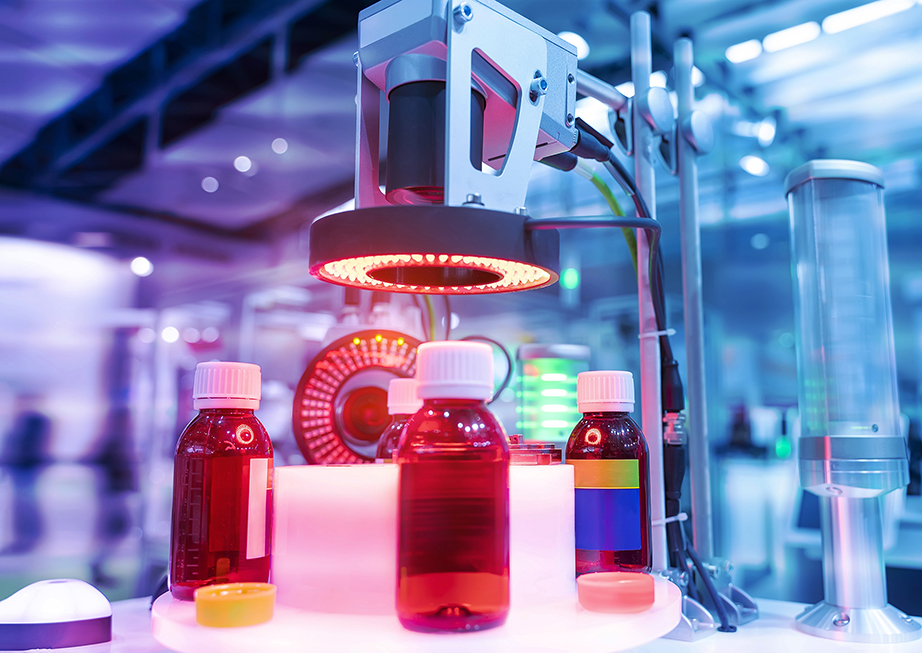 An assembly line with bottles being scanned by a visual inspection system