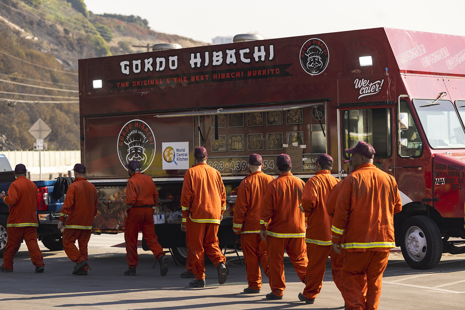 Firefighters line up at a food truck during wildfires in Southern California