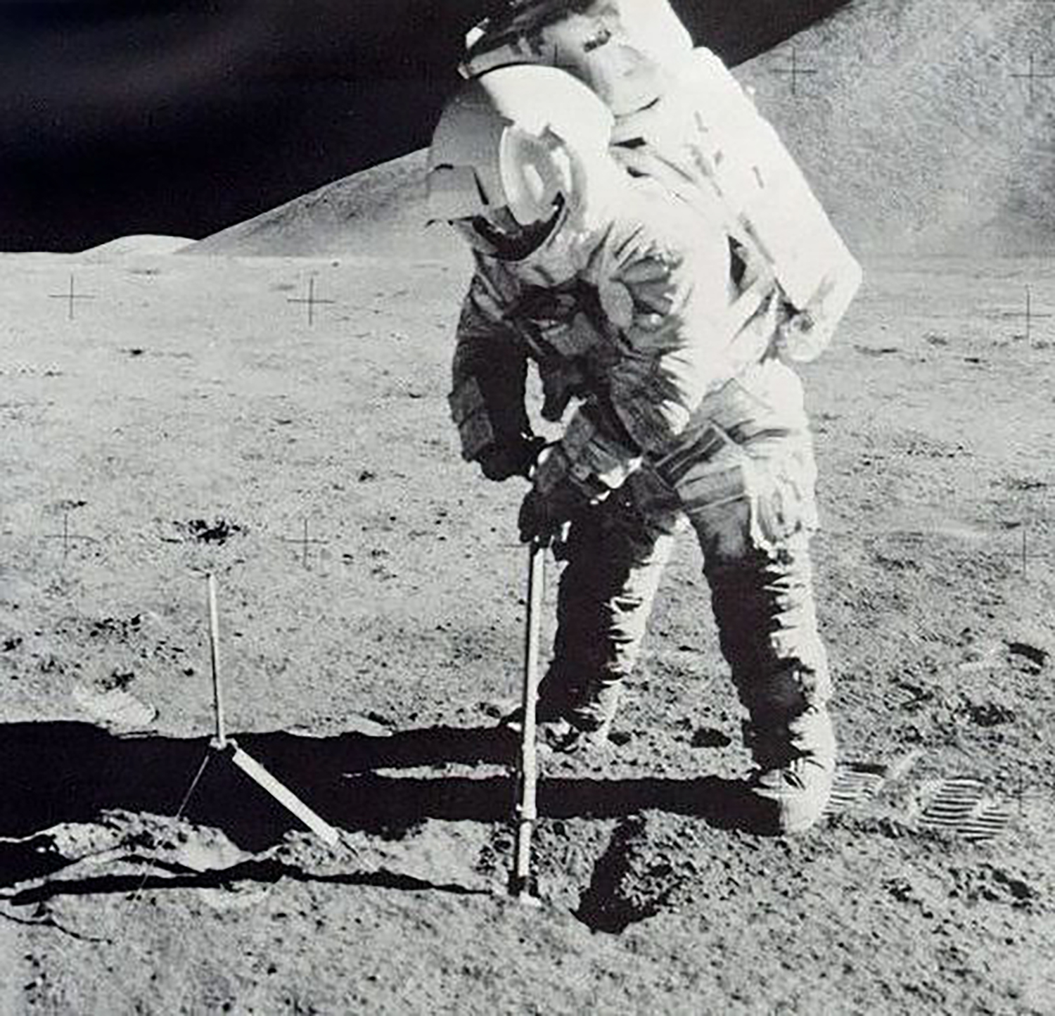 astronaut on moon scoops soil sample