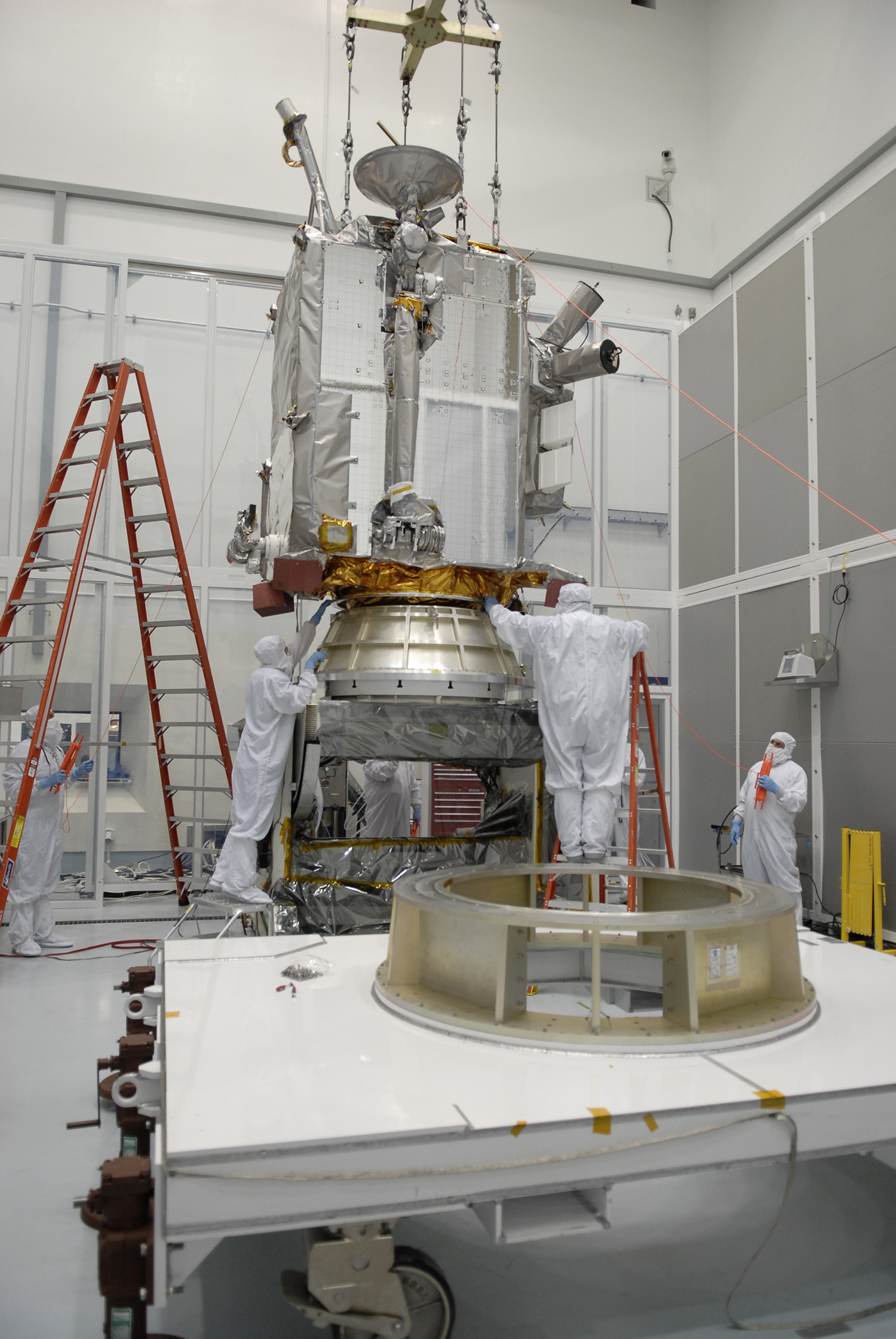 orbiter hangs from crane during assembly