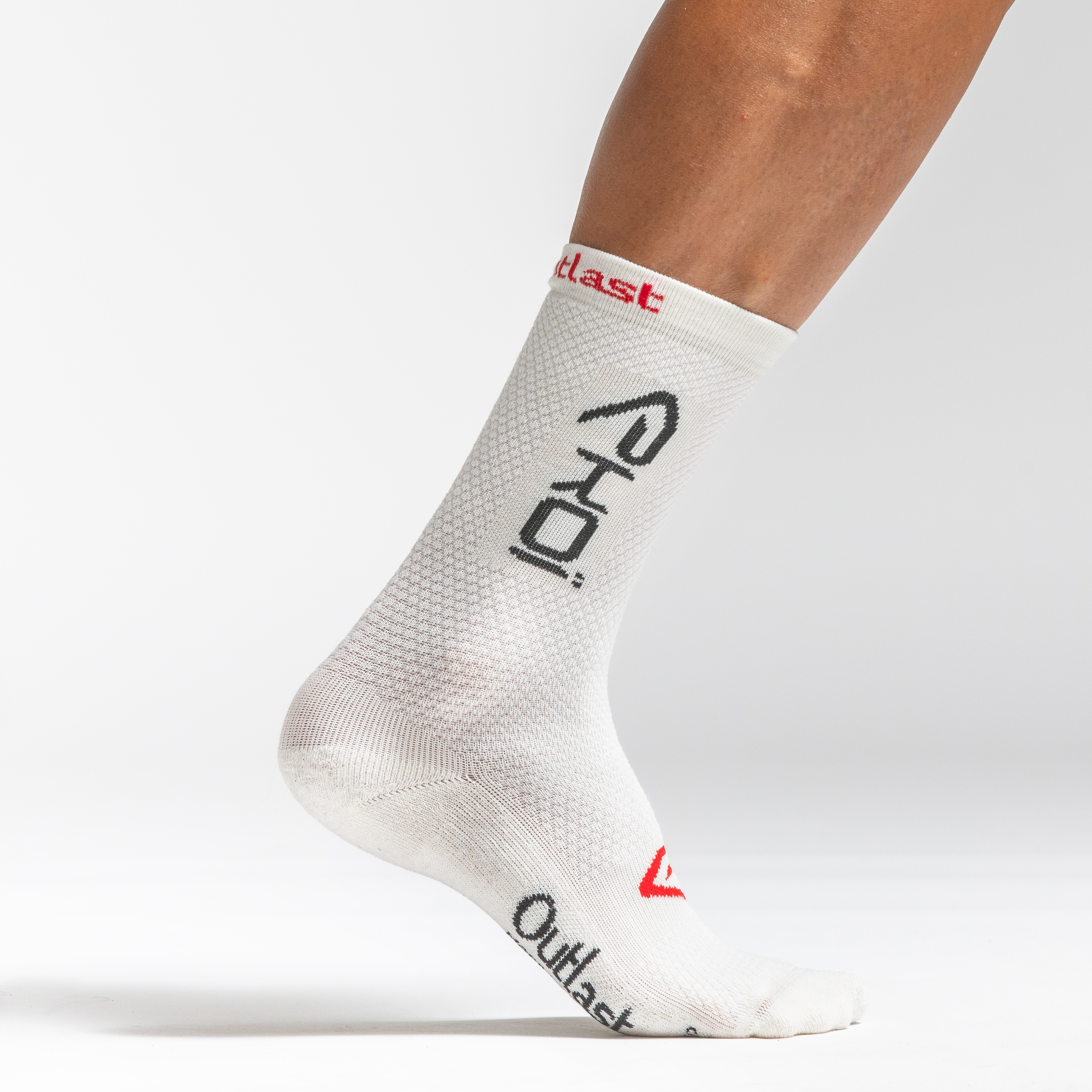 A foot adorned with a sock bearing the logos of Ekoi and Outlast