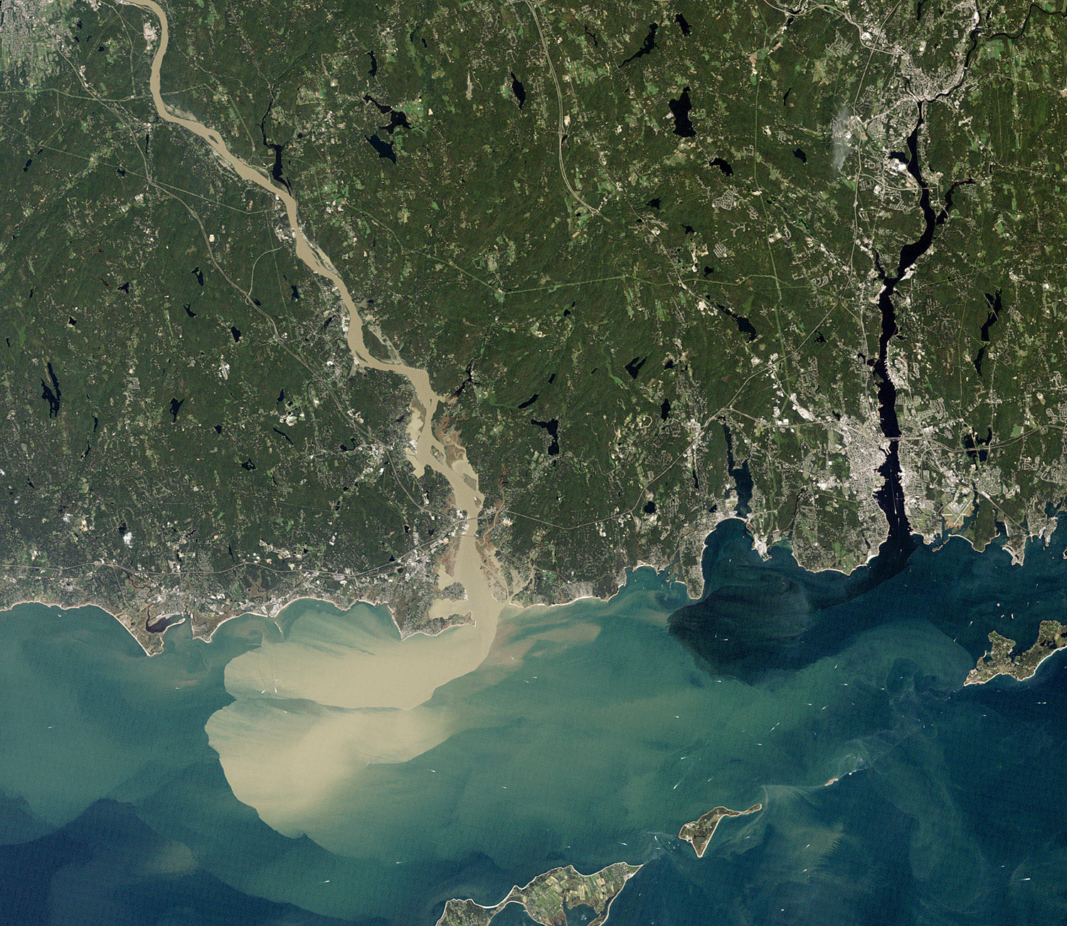 satellite view of river mouth emptying into a body of water