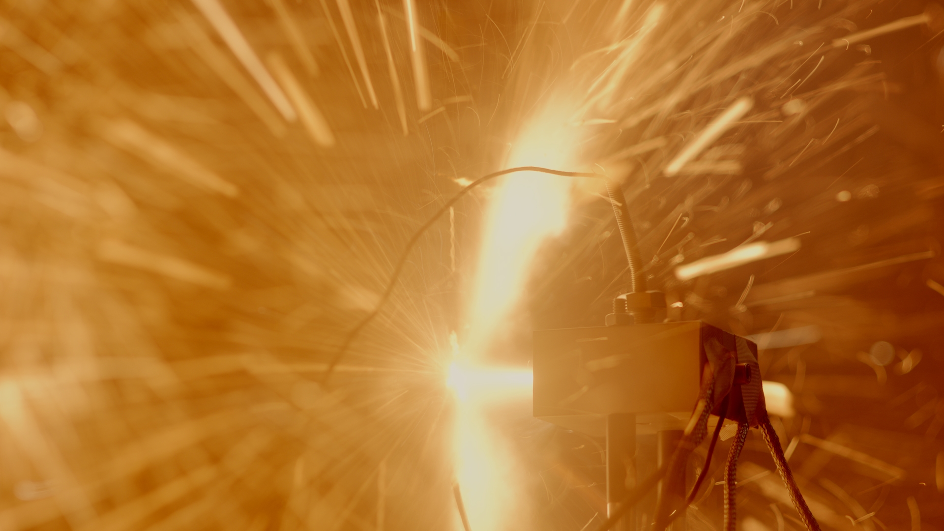 Bright sparks in a testing room as a battery is intentionally short-circuited