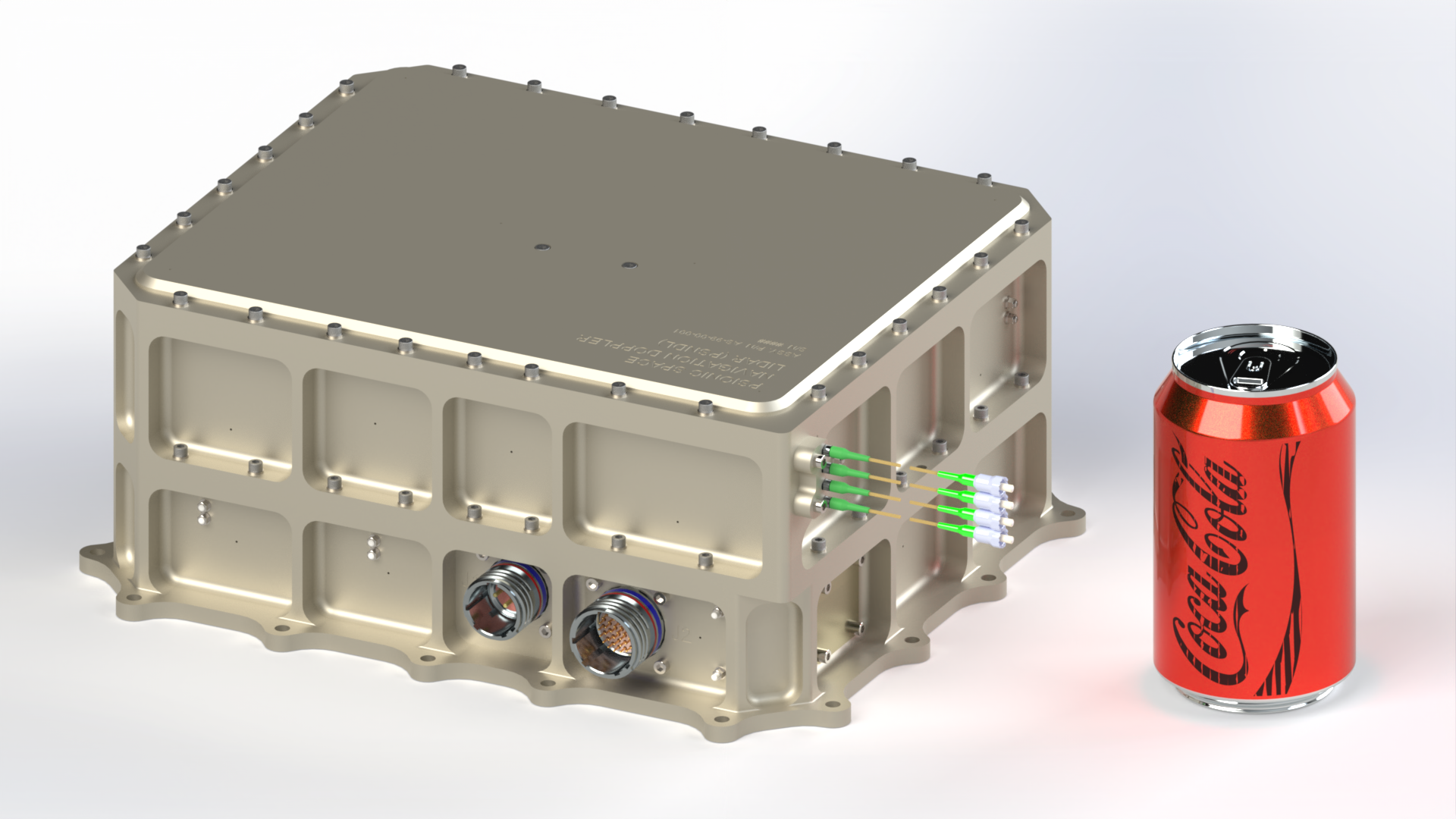 A Coca Cola can sits beside a metal box-shaped device that's slightly taller than it and about twice as long as the can is tall. 