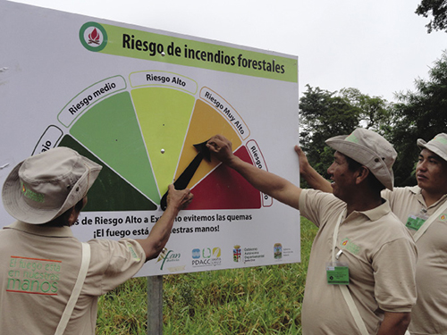 Men adjusting fire risk indicator in Bolivia