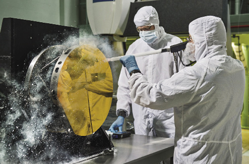 Engineers cleaning test mirror