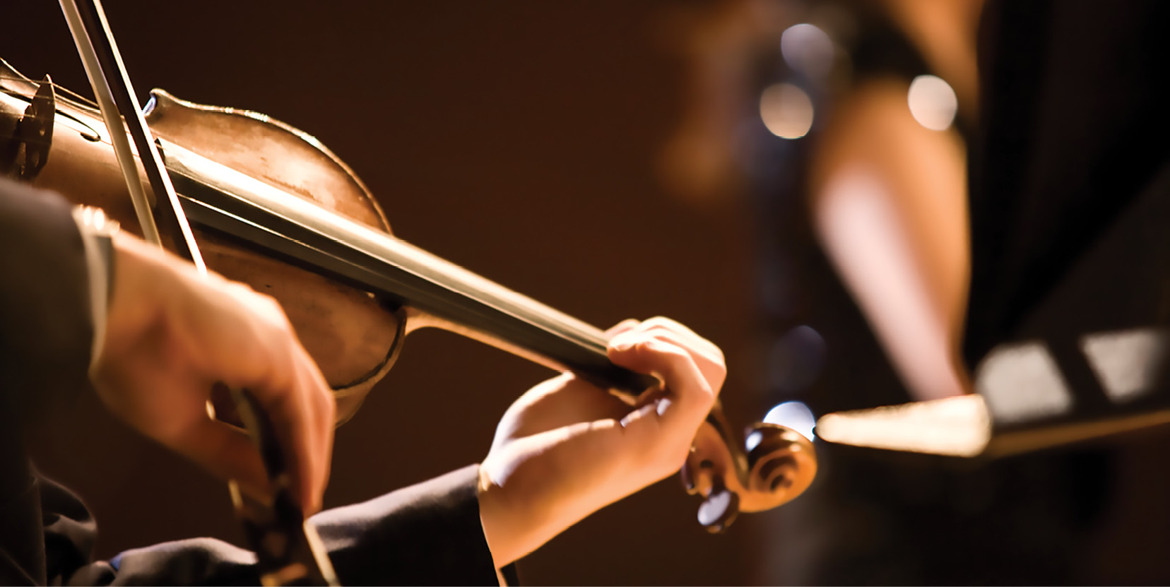 Closeup of hands playing a violin